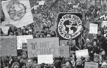  ?? MICHAEL SOHN, FILE/AP PHOTO ?? People take part in a “Fridays For Future” protest rally in Berlin, Germany, on March 3. A major new United Nations report released Monday provides a sobering reminder that time is running out if humanity wants to avoid passing a dangerous global warming threshold.