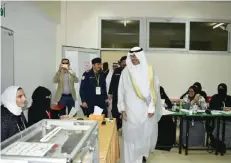  ??  ?? KUWAIT: Ahmadi Governor Sheikh Fawaz Al-Khaled Al-Hamad Al-Sabah is seen inside a polling center yesterday.