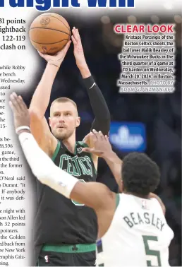  ?? PHOTO BY ADAM GLANZMAN/AFP ?? CLEAR LOOK
Kristaps Porzingis of the Boston Celtics shoots the ball over Malik Beasley of the Milwaukee Bucks in the third quarter of a game at TD Garden on Wednesday, March 20, 2024, in Boston, Massachuse­tts.
