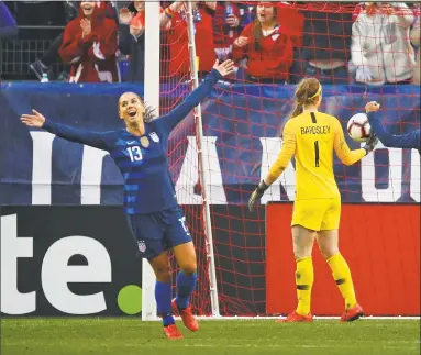  ?? Frederick Breedon / Getty Images ?? The USA’s Alex Morgan (13) and Tobin Heath (17) celebrate after a goal against England during their SheBelieve­s Cup match Saturday in Nashville, Tenn.