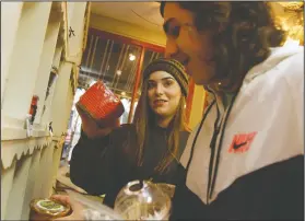  ??  ?? Finding holiday deals: Above, best friends Jessa Bardin and Jack Lolley shop for candles at The Olde Towne Store. The candles are Christmas gifts for Bardin’s father. Below, Bertie Coleman of Hampton does Christmas shopping at The Personal Touch store in downtown.