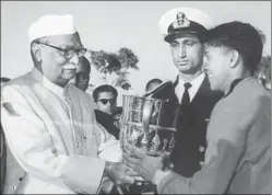  ??  ?? ■ Mohun Bagan captain Chuni Goswami (right) receiving the Durand Cup from President of India Rajendra Prasad, after being declared joint winners with East Bengal in 1960. HT FILE PHOTO