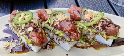  ?? Photos by Susie Davidson Powell / For the Times Union ?? Tuna tartare atop crisp rice cakes at Rhea in Saratoga Springs.