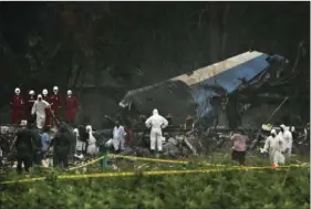  ??  ?? Rescue teams search through the wreckage site of a Boeing 737 that plummeted into a cassava field with more than 100 passengers on board, in Havana, Cuba, on Friday. The Cuban airliner crashed just after takeoff from Havana’s internatio­nal airport in...