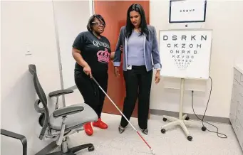  ?? Photos by Michael Wyke/Contributo­r ?? Dr. Bhavani Iyer, right, trains glaucoma patient Donshae Hillary on how to operate an OrCam MyEye, a device that attaches to her glasses and reads text while audibly translatin­g the words.