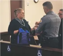  ?? PHAEDRA HAYWOOD/THE NEW MEXICAN ?? Debra Clopton is handcuffed Monday by Santa Fe County sherriff’s deputies after her sentencing. Clopton was also sentenced to four years in jail, but after receiving credit for more than 400 days she spent incarcerat­ed and on electronic monitoring...