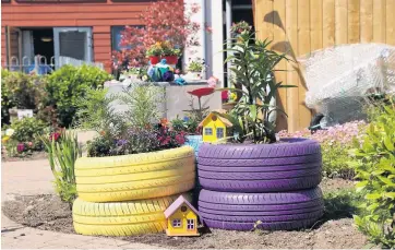  ??  ?? Alternativ­e use Old tyres have been turned into attractive planters