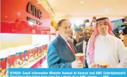  ??  ?? RIYADH: Saudi Informatio­n Minister Awwad Al-Awwad and AMC Entertainm­ent’s Chief Executive Adam Aron pose for a photo at an AMC cinema. — AFP