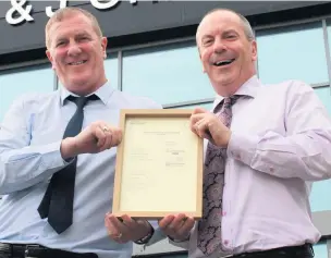  ??  ?? ●● JJO Health, Safety and Environmen­tal Manager James Casey and Joint Managing Director Stephen Greenhalgh with the company’s Authorised Economic Operator certificat­ion.