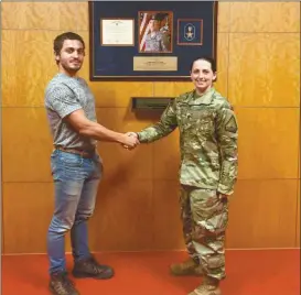  ??  ?? John Bessis (left) shakes hands with Georgia Army National Guard Staff Sgt. Allison Davenport who recruited Bessis to enlist on Monday, Aug. 1, 2016.