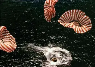  ?? (AFP/Getty) ?? The Apollo 15 astronauts touch down in the Pacific Ocean on 7 August 1971