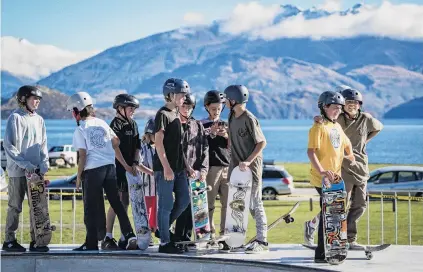  ?? PHOTOS: RAY TIDDY ?? Memsers of the soard . . . Young skaters stand sy during Wanaka Festival of Colour’s Cross the Line street performanc­e at the Wanaka skatepark on Qaturday. Right: A shop window in Helwick Qt decorated as part of the Wanaka Festival of Colour’s ‘‘Windows Over Wanaka’’ exhisition.