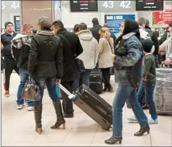  ??  ?? STEADY FLOW: Romanians taking a flight from Bucharest to Luton