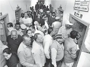  ?? ?? People queue up to cast their ballot during the first phase of Gujarat Assembly elections in Rajkot