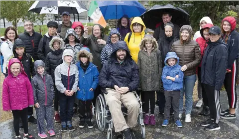  ??  ?? Some of the group from Kilmacanog­ue heading off to the World Meeting of Families on Sunday, cheerful despite the weather.