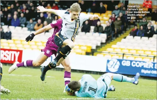  ?? PICTURE: MI News & Sport ?? THWARTED: Carlisle’s Joe Fryer blocks Nathan Smith’s attempt on goal
