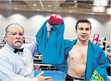  ?? Peter Lim / For the Chronicle ?? Middleweig­ht Radmir Akhmediyev, right, celebrated his May victory over Aaron Anderson at the Bayou City Events Center draped in the flag of his native Kazakhstan.