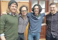  ?? SUBMITTED PHOTO ?? Ten Strings and A Goat Skin share the excitement of winning the ECMA Roots/Traditiona­l album of the year with their producer, Leonard Podolak second left, during a stop in the Shetland Islands where they are currently touring. From left are Rowan...