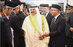  ??  ?? Sultan Muhammad V and Bahrain’s King Hamad Isa Al Khalifa meeting Malaysian ministers at Parliament in May this year during the Bahrain monarch’s state visit to Malaysia. — Bernama