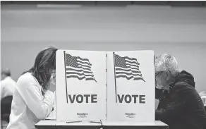  ?? ANDREW HARRER / BLOOMBERG ?? Voters cast ballots at a polling station in Mclean, Virginia, on Tuesday.