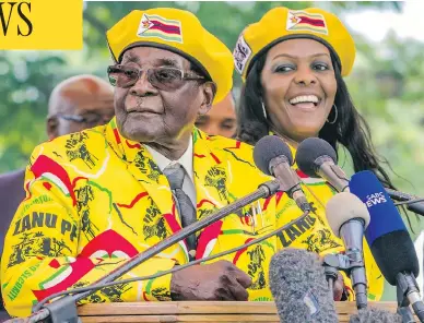  ?? JEKESAI NJIKIZANA / AFP / GETTY IMAGES ?? Zimbabwe President Robert Mugabe called on party members to support wife Grace Mugabe, right, as the party’s next vice- president at a rally last week. Tanks were seen near the capital of Harare on Wednesday, a day after army leaders warned they would...