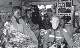  ??  ?? A Coast Guard photo published in 2012 shows Faulkner with four rescued Bahamian fishermen.