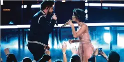  ??  ?? Thomas Rhett, left, and Maren Morris perform ‘Craving You’.