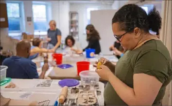  ?? Haldan Kirsch/ Post- Gazette ?? Daijah Massie of Baldwin Borough hand- glazes items she made from clay Wednesday at the Union Project in East Liberty.