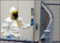  ??  ?? A firefighte­r from Prince George’s County, Md., in a protective suit enters a government mail screening site in Hyattsvill­e, Md., on Wednesday.