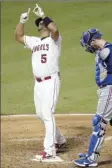  ?? AP photo ?? Albert Pujols of the Angels points skyward as he crosses home plate after hitting his 661st home run Friday.