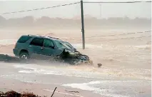  ??  ?? A car is trapped by floodwater­s from Hurricane Harvey in Point Comfort, Texas.