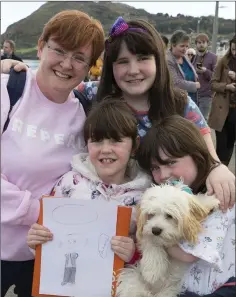  ??  ?? Claire Hayes, Calista Buckley (with her portrait of President Michael D Higgins), her sisters Lyra and Chara and their dog Khaleesi.