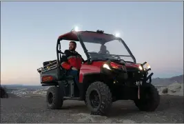  ?? ?? Daniel Medrano, right, fire chief of Sunland Park, N.M., and Mayor Javier Perea, who says that some are calling the town Little Amsterdam or the Dubai of marijuana, ride in an ATV on Mount Cristo Rey, the site of a popular religious shrine in the town in December.