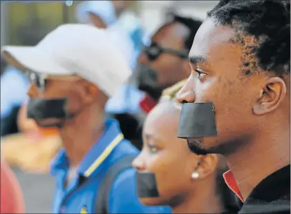  ?? Picture: RIAAN MARAIS ?? SEEKING PAYMENT: Artists from the PE Theatre Makers staged a silent protest at the Human Rights Day celebratio­n held at the Donkin Reserve in Port Elizabeth yesterday. They are, from left, Lubabalo Mbombela, Asenda Hanabe and Khanyile Mgqwanci