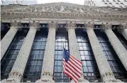  ?? [AP PHOTO] ?? An American flag flies outside New York Stock Exchange.