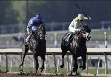  ?? ASSOCIATED PRESS FILE ?? Classic Empire, right, with Julien Leparoux aboard, charges to the finish line to win the Breeders’ Cup Juvenile horse race at Santa Anita Park in Arcadia Classic. Empire will be one of the 20 horses vying to wear the garland of red roses.