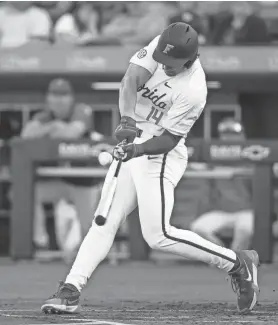  ?? DOUG ENGLE/GAINESVILL­E SUN ?? Florida’s Jac Caglianone connects with a pitch, hitting a fly out, in the Gators’ March 12 game against FSU.