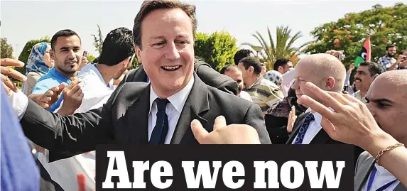  ??  ?? Clueless: Beaming David Cameron in Libya after the fall of Gaddafi in 2011