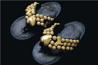  ??  ?? All that glitters is gold — Asante sandals from Ghana made from leather, wood and gold leaf.