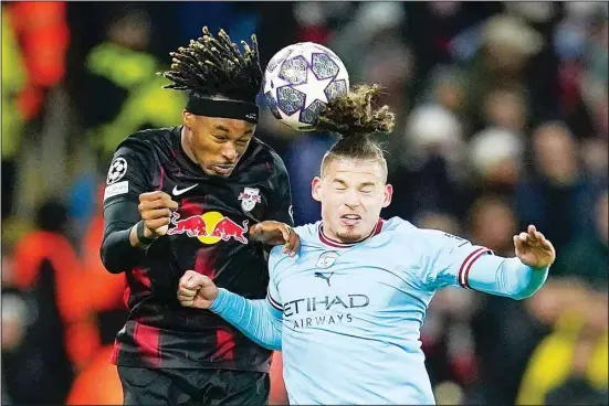  ?? ?? Leipzig’s Mohamed Simakan and Manchester City’s Kalvin Phillips (right), challenge for the ball during the Champions League round of 16 second leg soccer match between Manchester City and RB Leipzig at the Etihad stadium in Manchester, England. (AP)