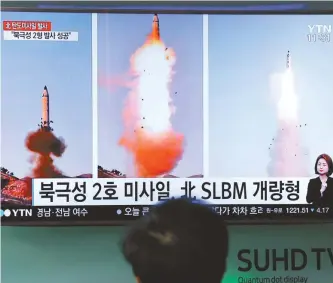  ?? AP-Yonhap ?? A man at a railway station in Seoul watches a TV news program showing North Korea’s Pukguksong-2 missile launch.