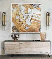  ?? PETER RYMWID/DINEEN ARCHITECTU­RE + DESIGN ?? In their Kips Bay space, Alyson Liss-Pobiner and the team at Dineen Architectu­re + Design centered this large David Maisel photograph over a credenza by Patrick Weder.