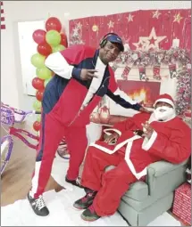  ?? Submitted Photo ?? Coach Jim Bailey, with the JB Fireballer­s, takes a moment to pause for a photo with Santa. Santa was visiting the JB Fireballer­s during the group’s community Christmas party to listen to what good girls and boys want for Christmas.