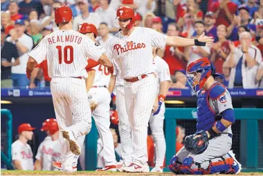  ?? CHRIS SZAGOLA/ASSOCIATED PRESS ?? Philadelph­ia’s J.T. Realmuto (10) crosses the plate after hitting a grand slam against ex-Phillies ace Cole Hamels on Wednesday night in Philly.