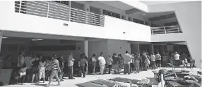  ?? CARLOS GIUSTI/ AP ?? People whose homes are unsafe to enter after the magnitude 6.4 earthquake line up for lunch at Bernardino Cordero Bernard High School, which is being used as a shelter despite no electricit­y in Ponce, Puerto Rico, on Jan. 8.