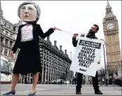  ?? PICTURES: REUTERS ?? Anti-Brexit protesters, one wearing a giant Theresa May head, hold placards outside Parliament yesterday in London.