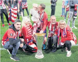  ??  ?? Atletico Madrid’s Antoine Griezmann, centre, celebrates winning the Europa League with his family.