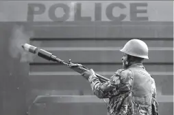  ?? NAIROBI
-AP ?? An anti-riot police officer fires tear gas to disperse supporters of Kenyan opposition National Super Alliance (NASA) coalition in Kenya.