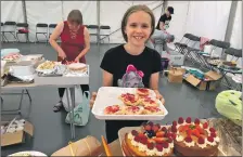  ?? ?? Mia Krawczyk serves up a Jubilee treat for the partygoers in Tarbert.