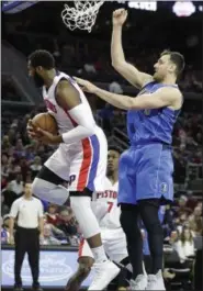  ?? CARLOS OSORIO — ASSOCIATED PRESS ?? Pistons center Andre Drummond, left, pulls down a rebound in front of Mavericks center Andrew Bogut during the first half Feb. 15 in Auburn Hills, Mich.